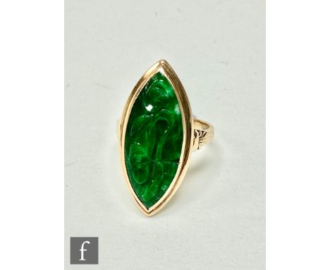 A 14ct single stone jade ring, marquise shaped stone  collar set to a stepped border, length 3cm, weight 6.5g, ring size J. 