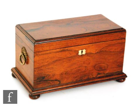 A 19th Century rosewood tea caddy fitted with two separate canisters and a central glass mixing bowl on stepped base and bun 