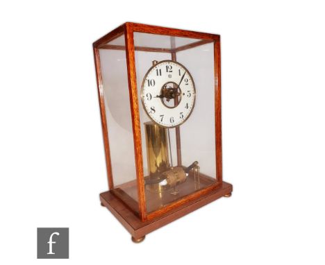 A mid 20th Century Bulle patent electric mantle clock, circular suspended dial over battery pendulum in oak glazed case on br
