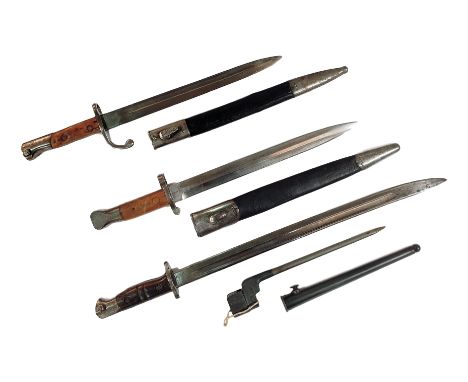 A 1913 Remington pattern bayonet, a similar bayonet, a Sanderson pattern bayonet and scabbard and a No 4 MK II socket bayonet