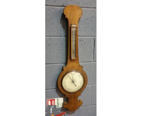 A 19th Century walnut wheel barometer incorporating a thermometer, height 92.5cm. 