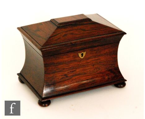A 19th Century rosewood tea caddy of concave form fitted with two divisions, on bun feet, width 23cm. 