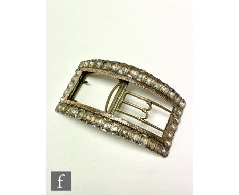A Regency period paste set sash or shoe buckle of arched section, paste set to the border with graduated stones to the white 