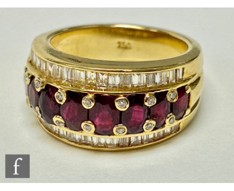 An 18ct ruby and diamond ring, eight graduated oval claw set rubies each flanked above and below with channel set row of bagu