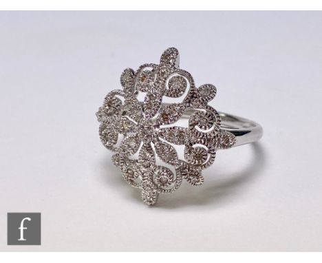 A 9ct hallmarked white gold diamond cluster ring modelled as a snowflake, width of head 20mm, weight  3.5g, ring size S. 