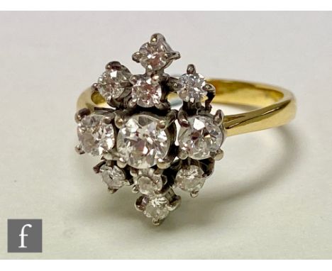 An 18ct hallmarked diamond cluster ring comprising eleven individually claw set transitional cut stones to knife edged should