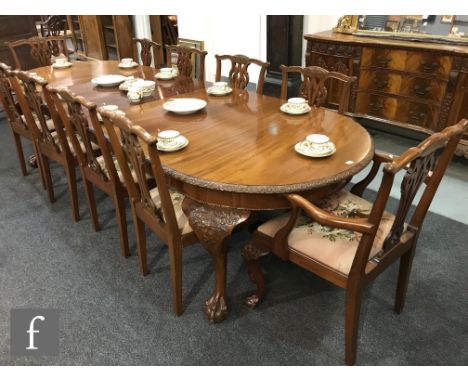 A set of ten Chippendale style carved dining chairs and a matching extending dining table detailed moulded edge on carved cab