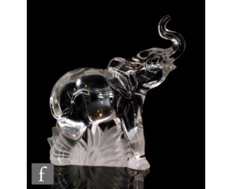 A later 20th Century Steuben clear crystal figure of an Elephant in walking pose with trunk raised, unmarked, height 17cm. 