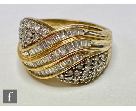 A 9ct hallmarked diamond cluster ring, three central rows of channel set baguette stones with two pave set panels to either s