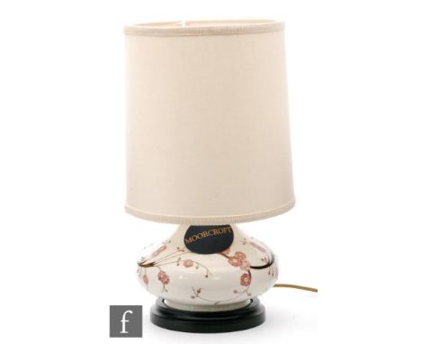 A Moorcroft Pottery lamp base, designed by Paul Hilditch, of compressed form decorated in the Sakura pattern, boxed with shad