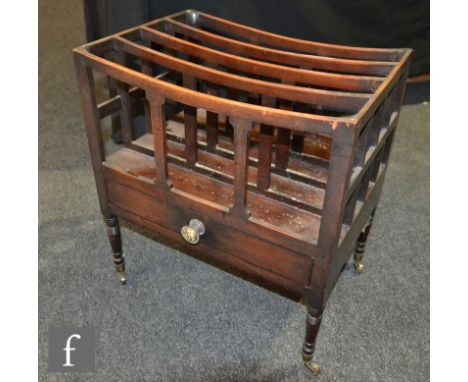 A George IV mahogany four divisioned Canterbury with single drawer on ring turned legs and brass castors, height 50cm x depth
