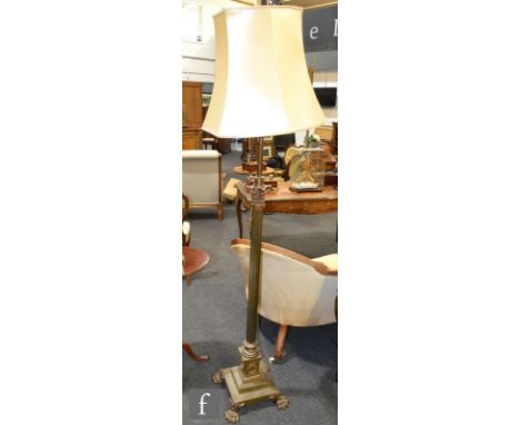 An early 20th Century a brass Corinthian column standard lamp on stepped base 
