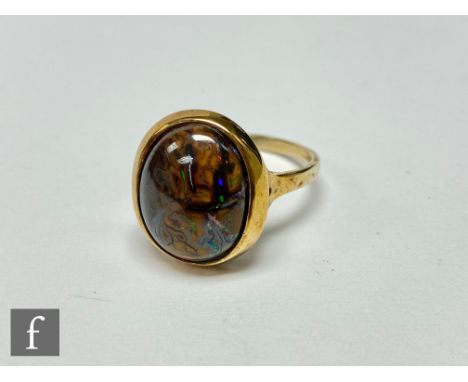 A 9ct hallmarked single stone boulder opal ring, collar set stone to plain shoulders, weight 5.3g, ring size T. 