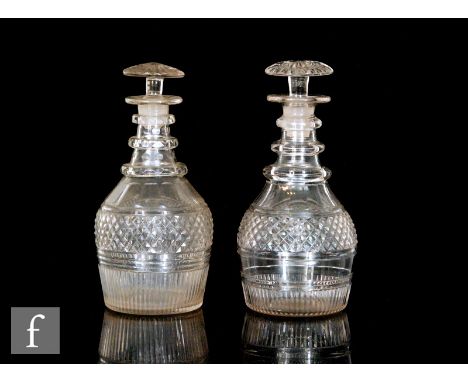A pair of early 19th Century Prussian form decanters circa 1830, each with bands of cut and polished decoration beneath a thr