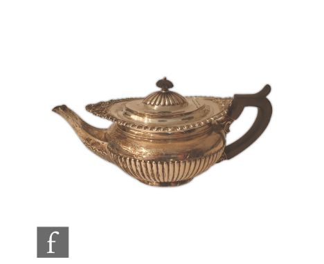 A hallmarked silver boat shaped tea pot with part fluted decoration and scalloped border, length 30cm, weight 27.5oz, London 