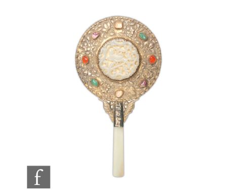 A late Qing Dynasty (1644-1912) Chinese lady's white metal hand mirror, with carved inset jade reticulated carving, mounted o