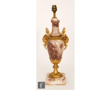 A late 19th Century pink veined marble and ormolu lamp base of baluster form with gilt ram's head and leaf details, height 48