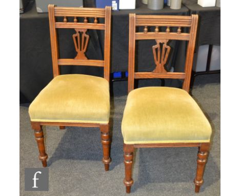 A set of six late Victorian light oak standard or side chairs, with turned and reeded backs above over-stuffed seats and turn