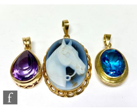 Two 18ct single stone pendants, a pair shaped amethyst and a blue zircon, with an 18ct oval cameo brooch of a horse's head, t