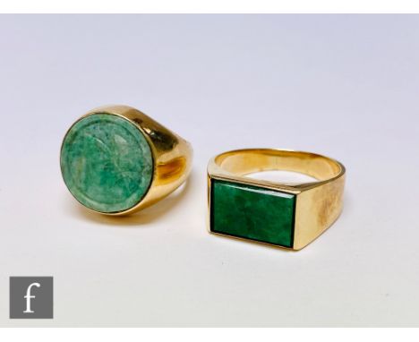 Two mid 20th Century 14ct gentleman's jade rings, one with a rectangular head, the other with a circular head, total weight 2