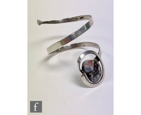A Sterling silver arm cuff bangle detailed with collar set polished agate, impressed Sterling Bali. 