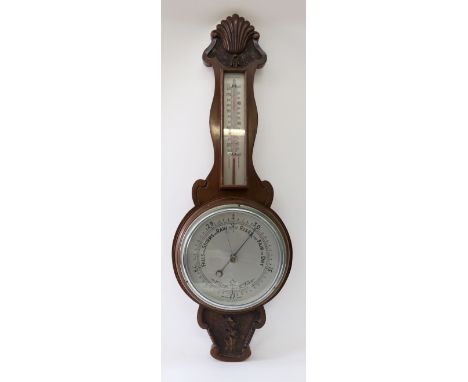 A carved mahogany case barometer/thermometer, 66cm high.