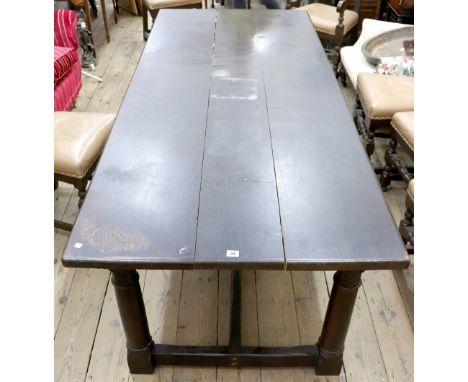 A reproduction 17th century style oak refectory table, the planked top on four gun barrel turned legs united by a stretcher, 