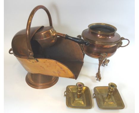 A copper helmet coal scuttle and scoop, early 19th century copper samovar, altered, on cast supports with ring handles, lacks