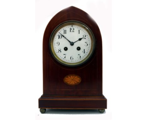 An Edwardian mahogany boxwood strung lancet top mantel clock, inlaid with a fan paterae oval, the white enamel dial with Arab