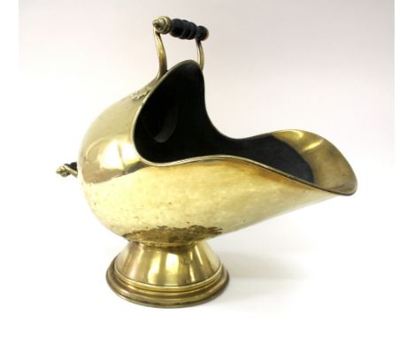 A Victorian brass helmet coal scuttle, with turned ebonised handles 48cm across.