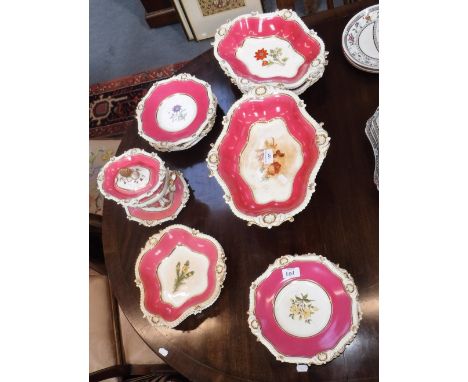 A 19TH CENTURY COALPORT STYLE DESSERT SERVICE, decorated with botanical specimens within a pink and gilt border 