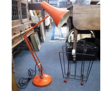 A VINTAGE ORANGE ANGLEPOISE LAMP and a 1950s wire magazine stand, with red ball finials (after Eames) (2)