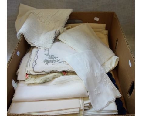 A VINTAGE LINEN TABLECLOTH with fancy edging and a collection of similar table cloths and textiles 