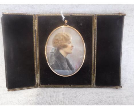 A PORTRAIT MINIATURE of a lady, head and shoulders, hand painted on ivory, in a fitted three fold presentation case