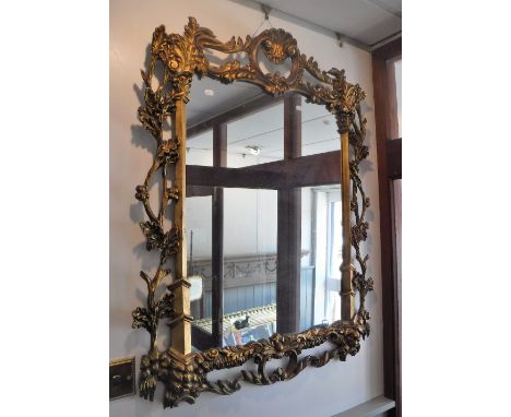 A CHIPPENDALE STYLE CARVED AND GILT WALL MIRROR, 85 cm wide, 108 cm high