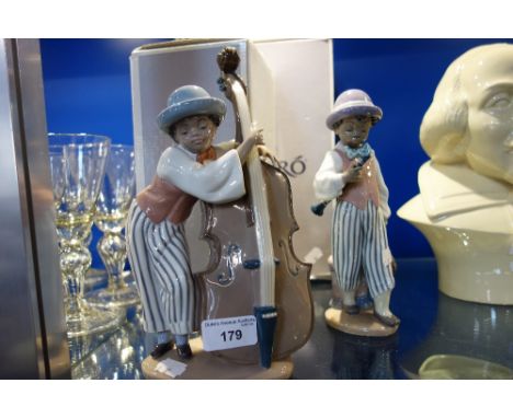 LLADRO; A STUDY OF A BOY PLAYING THE DOUBLE BASS, 25.5 cm high and another with a clarinet, 22 cm high (2) with boxes