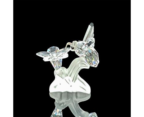 Clear crystal bee over a clear flower on a frosted leaf. Bee with rhodium antenna and black crystal eyes. Swarovski acid mark