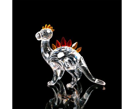Crystal dinosaur with clear body and black crystal eyes. Orange crystal scales located on the top of the head with red, yello
