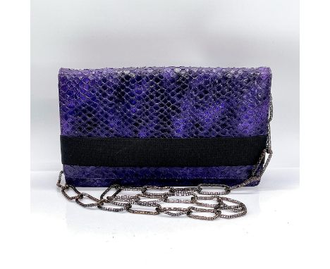Unusual leather handbag in a purple and black snakeskin pattern that can be worn as a clutch or with lightweight bronze metal