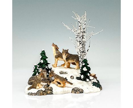 Department 56 figurine ""Wolves in the Woods"". Shows a pack of wolves on a snowy rock hill. This item has its original box. 