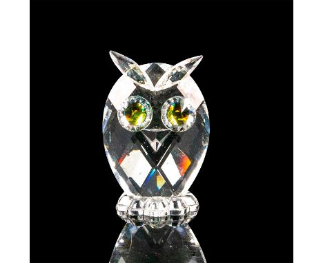 This miniature owl is made of clear crystal with its eyebrows going past its head and a feathered patterned bottom. The owl h