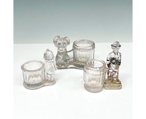 Includes Kewpie, Charlie Chaplin and a Dog. Kewpie; clear pressed glass candy container depicting a Kewpie doll by the barrel