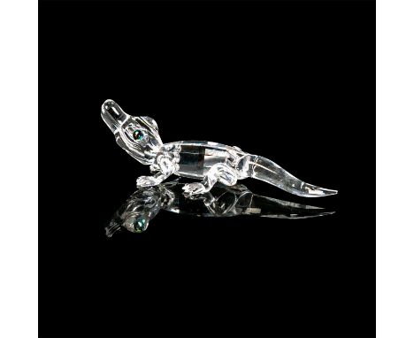 Miniature alligator facing upwards with clear crystal body. Cantaloupe colored crystal eyes with black crystal pupils. Swarov
