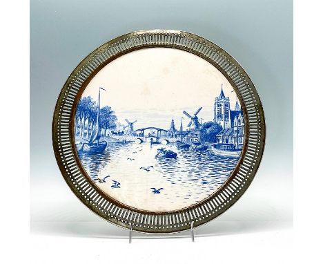 Blue and white glazed ceramic depicting scene of a boat on the river heading towards a draw bridge with windmills in the land