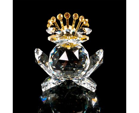Faceted crystal figurine modeled as a frog with gold tone metal crown studded with yellow crystals and pearlescent center. He