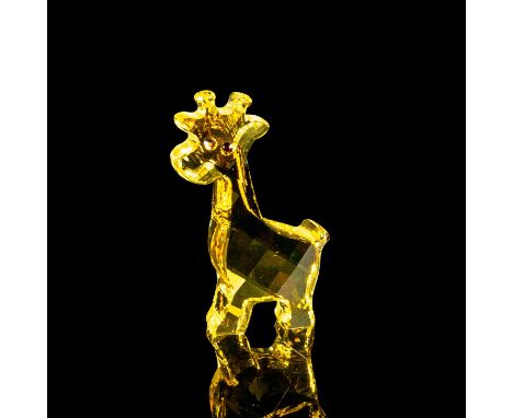 Yellow faceted crystal figurine modeled as an adorable giraffe with amber colored crystal eyes. Swarovski acid mark to base. 