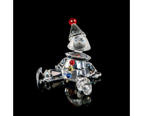 Miniature puppet figurine made of clear crystal, the head and face are frosted. This piece includes a red crystal on the hat.
