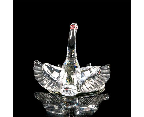 Faceted crystal figurine modeled as a swan mother protecting her three cygnets. This item has its original box. Swarovski aci