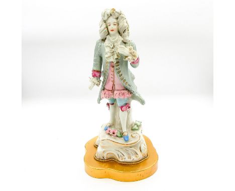 Depicts elegantly dressed gentleman with gold accents to porcelain base. Attached to metal lamp base.Dimensions: 12" HManufac