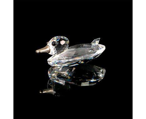 This miniature duck figurine is made of crystal for its entire body. The duck's bill is a silver-colored metal. It has black 